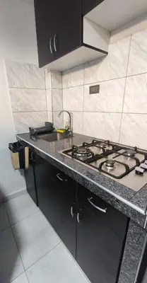 a kitchen with a stove and a counter top at Departamento centro in Andahuaylas