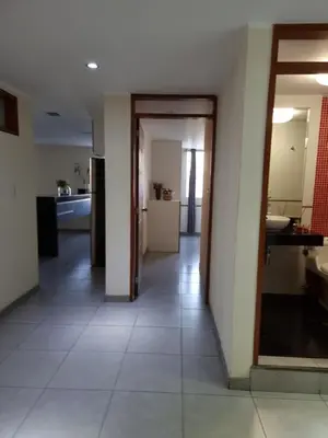 a hallway leading to a kitchen and a bathroom at Hermoso Departamento en Pueblo Libre in Lima