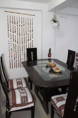 a dining room with a table and two chairs at Cusco Perú Apartment in Cusco