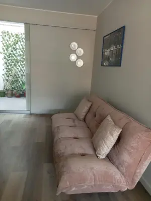a living room with a couch in the corner at Lindo mini apart Pueblo libre Lima in Lima