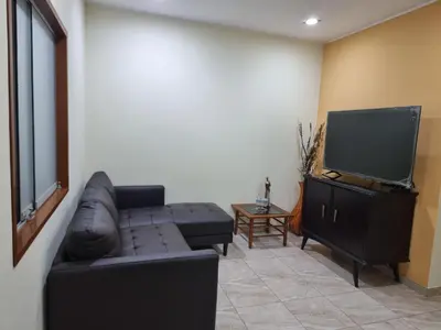 a living room with a couch and a flat screen tv at Hermoso Departamento en Pueblo Libre in Lima