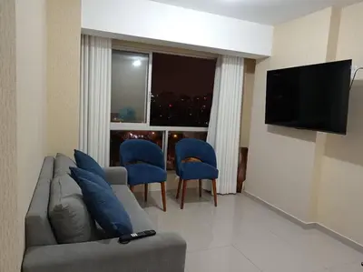 a living room with a couch and chairs and a television at Apartamento cómodo, como tu hogar in Lima