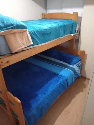two bunk beds with blue sheets in a room at Apartamento cómodo, como tu hogar in Lima