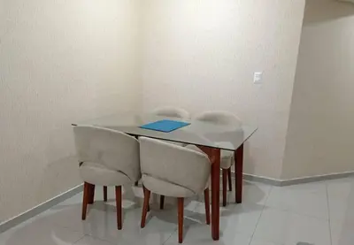 a dining room table with chairs and a blue book on it at Apartamento cómodo, como tu hogar in Lima