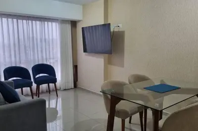 a waiting room with a glass table and chairs at Apartamento cómodo, como tu hogar in Lima
