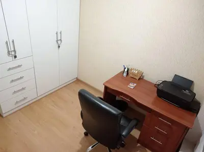 an office with a desk with a black chair at Apartamento cómodo, como tu hogar in Lima
