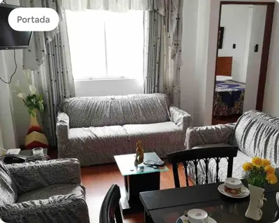 a living room with a couch and a table at Edificio La Católica in Lima