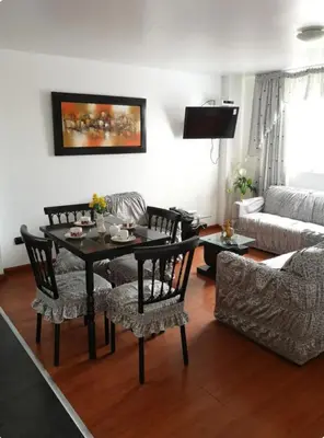 a living room with a table and chairs and a couch at Edificio La Católica in Lima