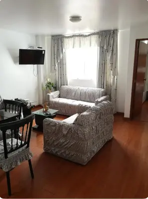 a living room with a couch and a window at Edificio La Católica in Lima