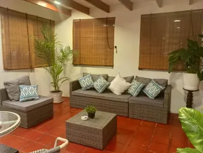 a living room with a couch with pillows at Habitación con vista al mar in Lima