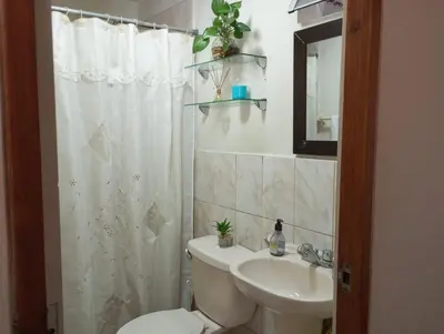 a bathroom with a toilet and a sink at Habitación con vista al mar in Lima