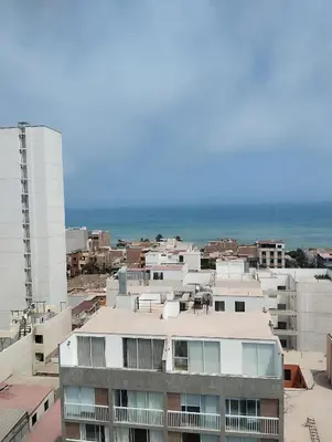 a view of a city with the ocean in the background at Habitación con vista al mar in Lima
