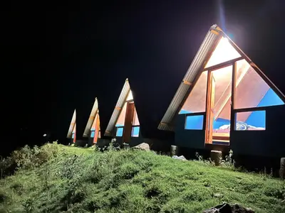 a row of houses on a hill at night at Salkantay Lodge Collpapampa in Colcapampa