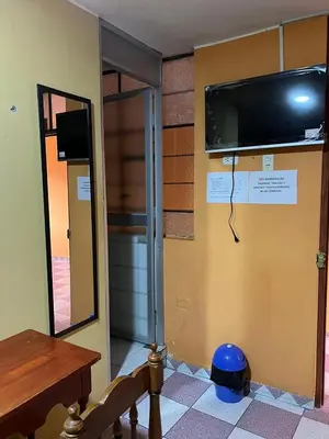 a room with a flat screen tv on a wall at Hospedaje El Centro in Ayacucho