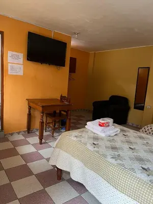 a room with a bed and a television on the wall at Hospedaje El Centro in Ayacucho