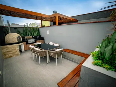 a patio with a table and chairs on a balcony at Beautiful and Well Located in Lima
