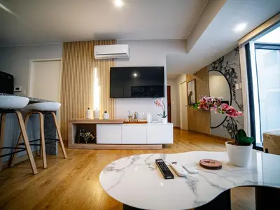 a living room with a table and a kitchen at Beautiful and Well Located in Lima