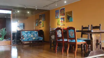 a room with chairs and a table and a table at Penthouse in the centre of Miraflores in Lima