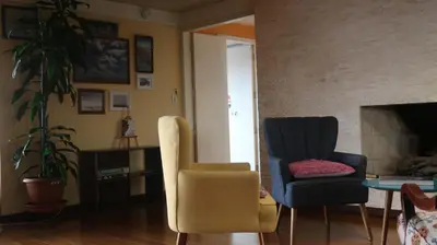a living room with two chairs and a table at Penthouse in the centre of Miraflores in Lima