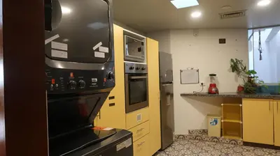 a kitchen with a black refrigerator and a stove at Penthouse in the centre of Miraflores in Lima