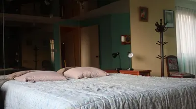 a bedroom with a bed with two pillows on it at Penthouse in the centre of Miraflores in Lima