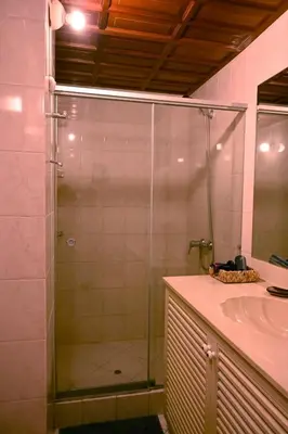 a glass shower in a bathroom with a sink at Gran Olivar Suite de San Isidro -3 Habitaciones in Lima