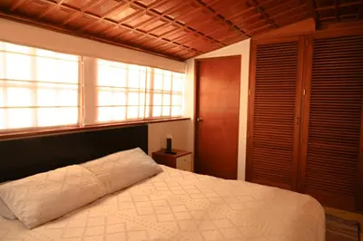 a bedroom with a large bed and a window at Gran Olivar Suite de San Isidro -3 Habitaciones in Lima