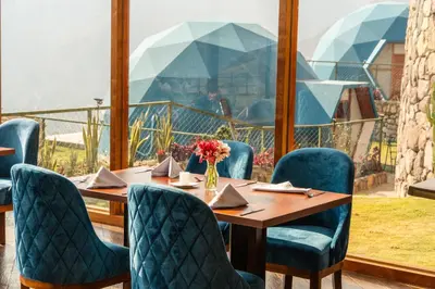 a dining room with a table and blue chairs at Memorable Sacred Experience in Cusco