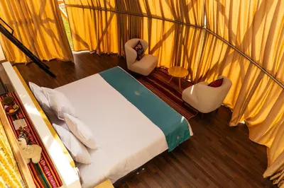 an overhead view of a bedroom with a bed and chairs at Memorable Sacred Experience in Cusco