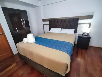 a bedroom with a bed with two towels on it at Anata Hotel in Cusco