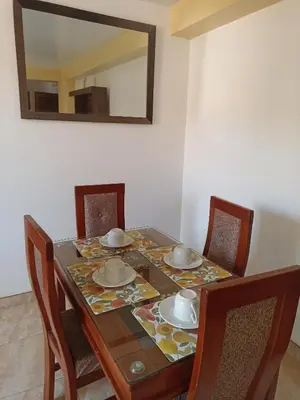 a dining room table with chairs and a mirror at Templo Home in Cusco