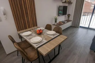 a dining room with a table and chairs at Cozy modern heart of city in Cusco