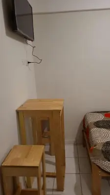 a room with a table and a tv and a bed at Samay Ñawi Wasi in Cusco