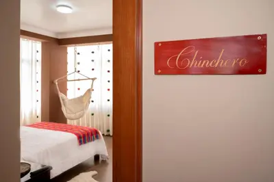 a bedroom with a bed and a hanging swing at Vive Chinchero in Ayarmaca