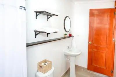 a bathroom with a toilet and a sink and a mirror at Vive Chinchero in Ayarmaca