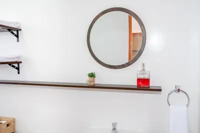 a mirror on a shelf above a bathroom sink at Vive Chinchero in Ayarmaca