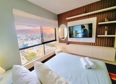 a bedroom with a bed and a large window at FlatTOP San Isidro City View Lima 3B 1804 in Lima