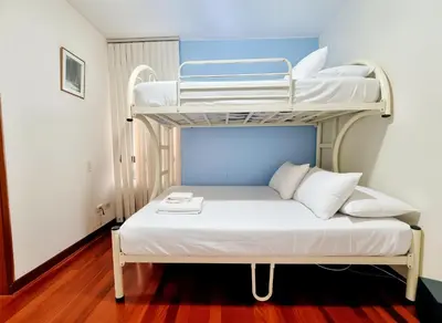 a bed with two bunk beds in a room at FlatTOP San Isidro City View Lima 3B 1804 in Lima