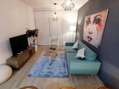 a living room with a blue couch and a tv at Barranco-Miraflores, ubicación A1, hermosa vista in Lima