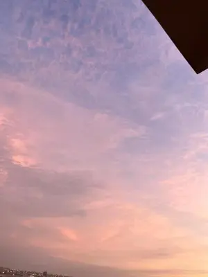a blue sky with a pink at Romi Apartment in Lima
