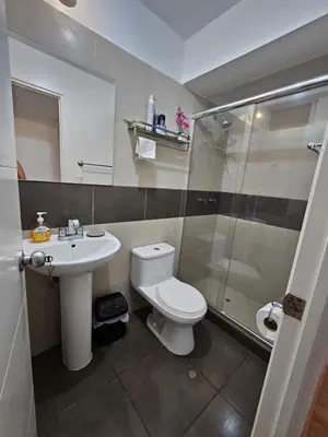 a bathroom with a toilet and a sink and a shower at Flat Arenales in Lima