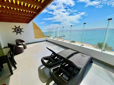 a living room with a view of the ocean at Suite 1ra Fila Vista Bahía Paracas - Sotavento 601 T3 in Paracas