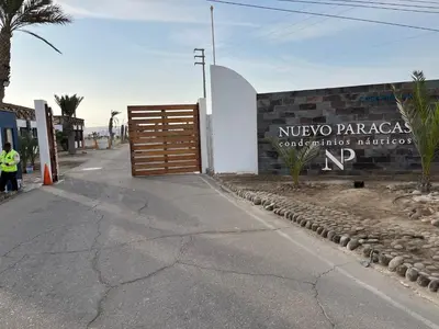 a entrance to a building with a wooden gate at Suite 1ra Fila Vista Bahía Paracas - Sotavento 601 T3 in Paracas