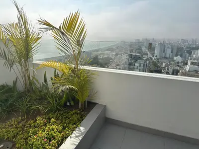 a balcony with plants and a view of a city at San Isidro, lindo depa , 2tv wifi, piscina, lavanderia in Lima