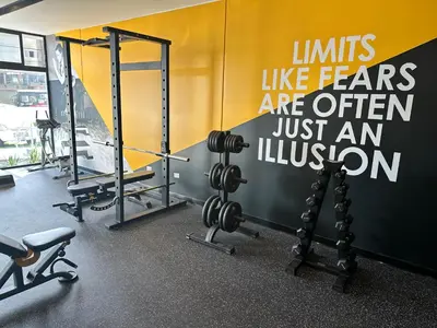 a gym with dumbbells and weights on a wall at San Isidro, lindo depa , 2tv wifi, piscina, lavanderia in Lima