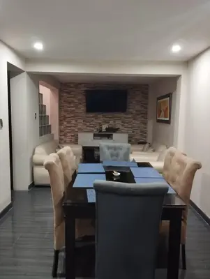 a dining room with a table and chairs at Departamento Duplex Aeropuerto y plaza cerca de ti! in Lima