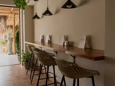 a bar in a restaurant with chairs and lights at Narea San Bartolo in San Bartolo