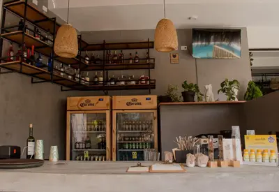a restaurant with a counter with bottles of alcohol at Narea San Bartolo in San Bartolo