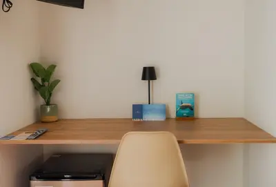 a wooden desk with a chair and a book on it at Narea San Bartolo in San Bartolo