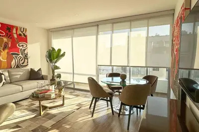 a living room with a couch and a table at Departamento de lujo Miraflores con Aire Acondicionado in Lima